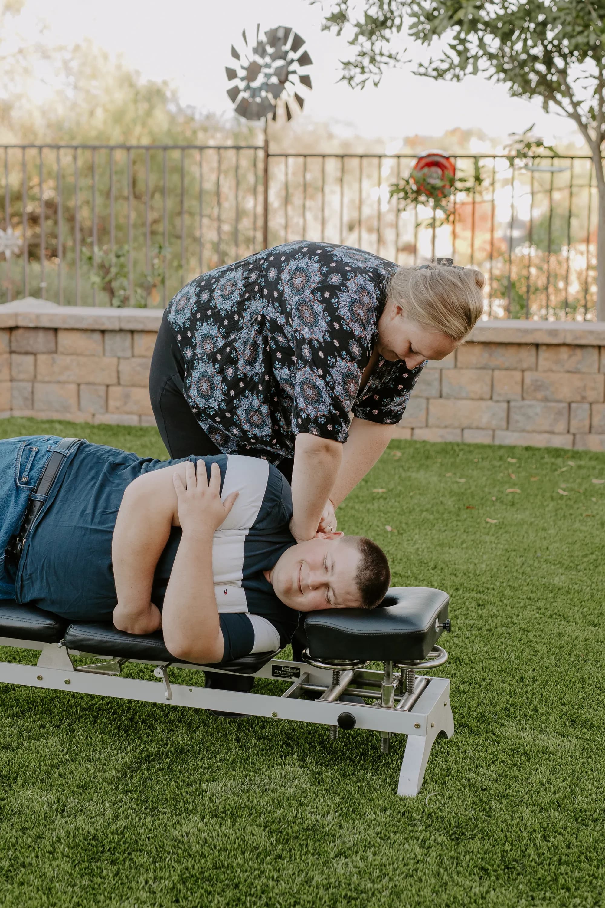Dr. Caitlin Walker delivering a gentle upper cervical adjustment outdoors in Oceanside